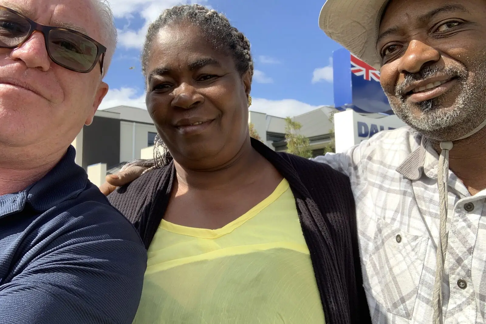 Happy investor clients outside their new property